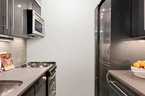 a kitchen with a sink appliances and cabinets