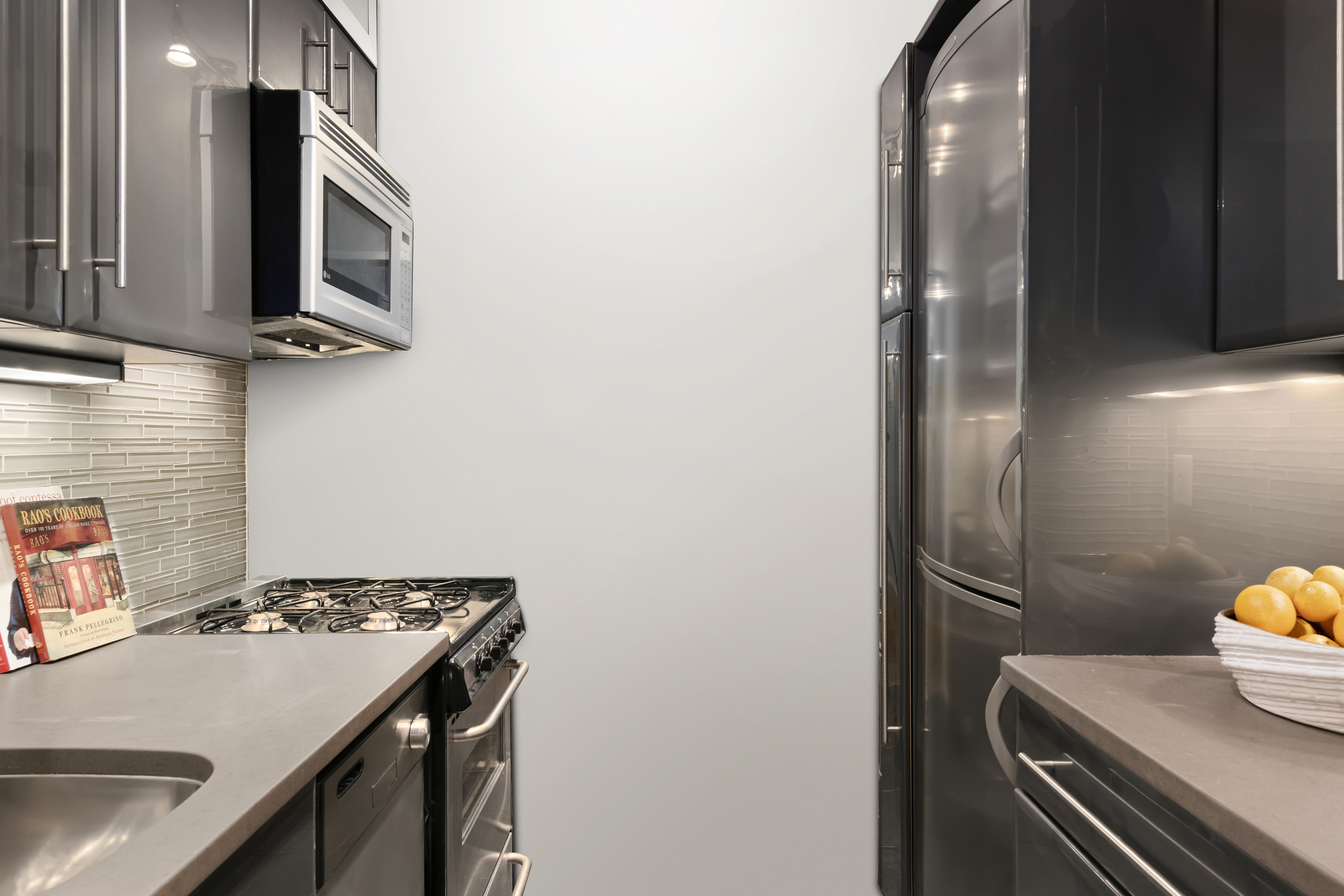 20 East 9th Street, Unit 9R Manhattan, NY 10003 - Photo 4 of 22 a kitchen with a sink appliances and cabinets