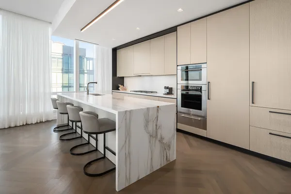 a kitchen with a table chairs refrigerator and cabinets