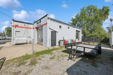 a view of a patio with a table and chairs and floor to ceiling window