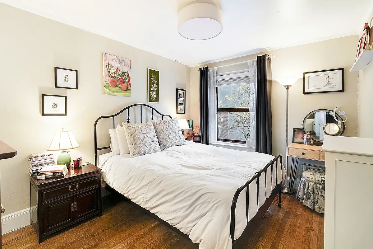 240 East 24th Street, Unit 4G Manhattan, NY 10010 - Photo 5 of 9 a bedroom with a bed and wooden floor