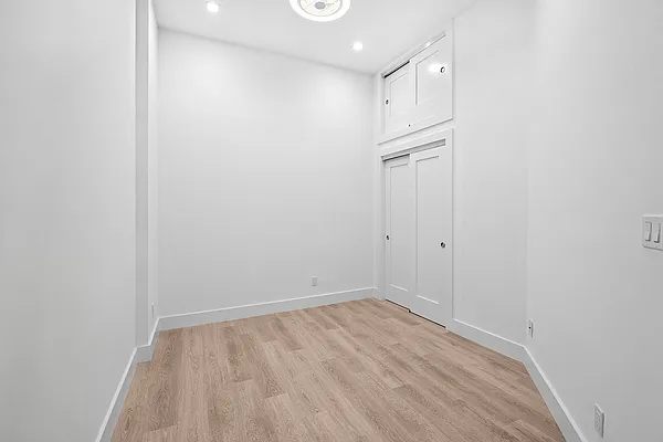 74 Leonard Street, Unit 4B Manhattan, NY 10013 - Photo 4 of 6 a view of empty room with wooden floor