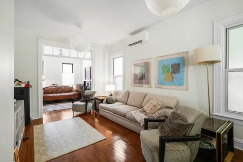 a living room with furniture and a lamp