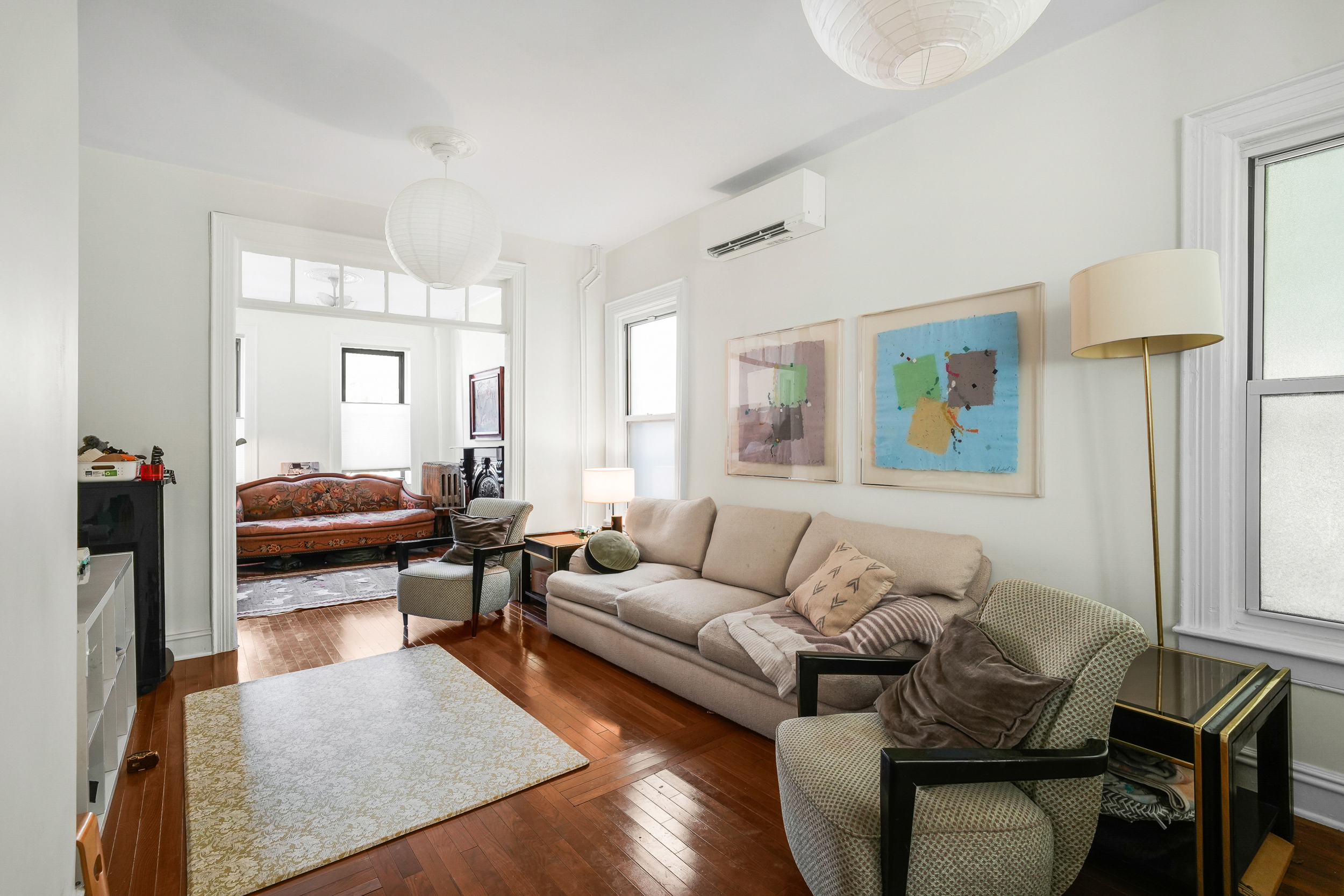 252 Jackson Street Brooklyn, NY 11211 - Photo 5 of 16 a living room with furniture and a lamp