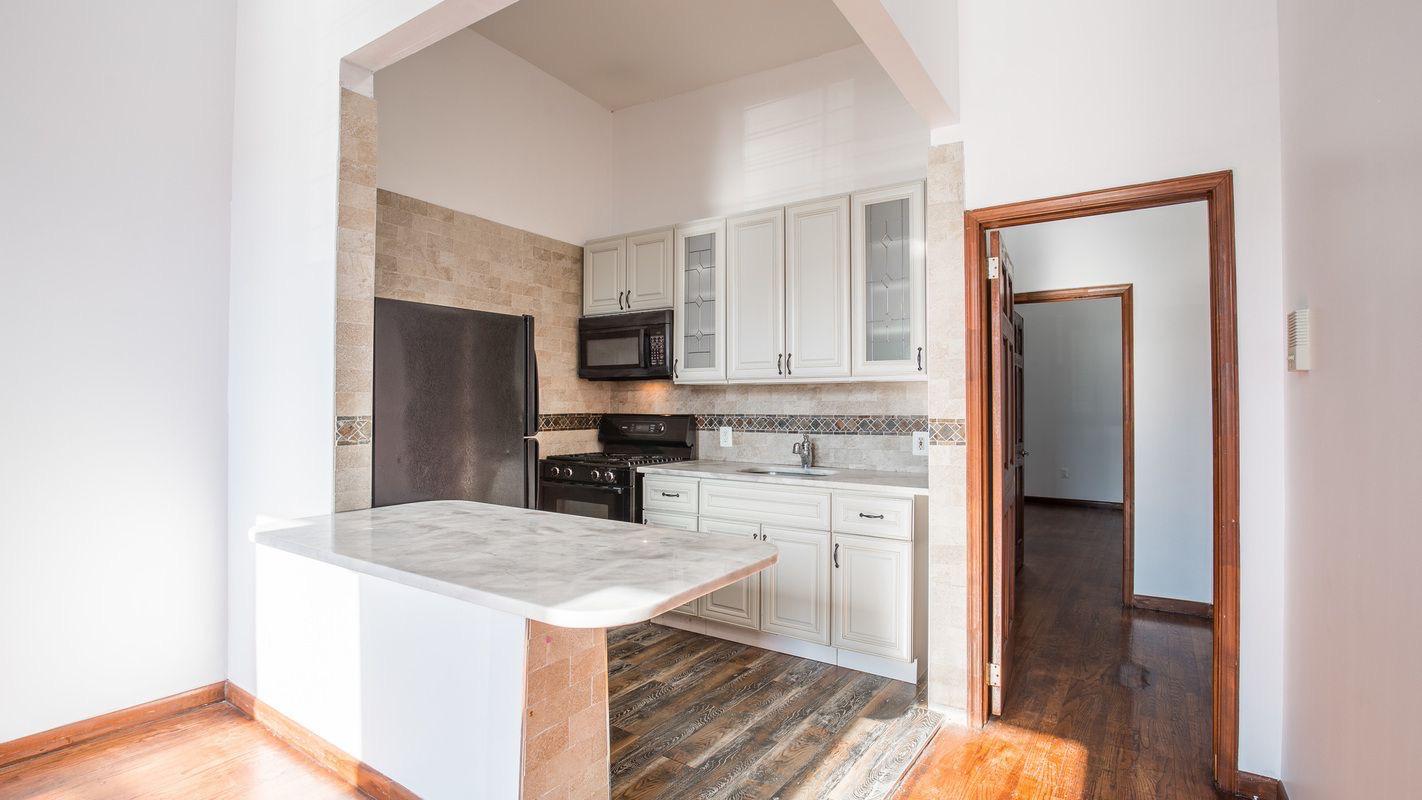 27 Brevoort Place, Unit 2 Brooklyn, NY 11216 - Photo 2 of 9 a kitchen with a refrigerator sink and cabinets