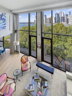 a bedroom with furniture and a large window