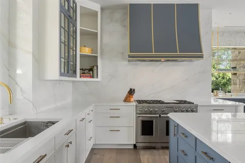 a kitchen with cabinets appliances and a sink