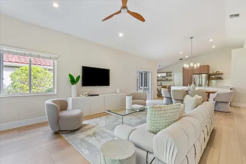 a living room with patio bathtub and a chandelier