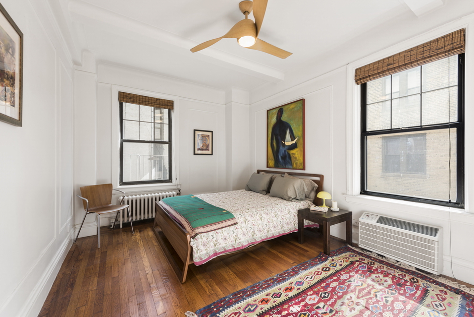 170 2nd Avenue, Unit 5E Manhattan, NY 10003 - Photo 5 of 10 a bedroom with a bed wooden floor and window