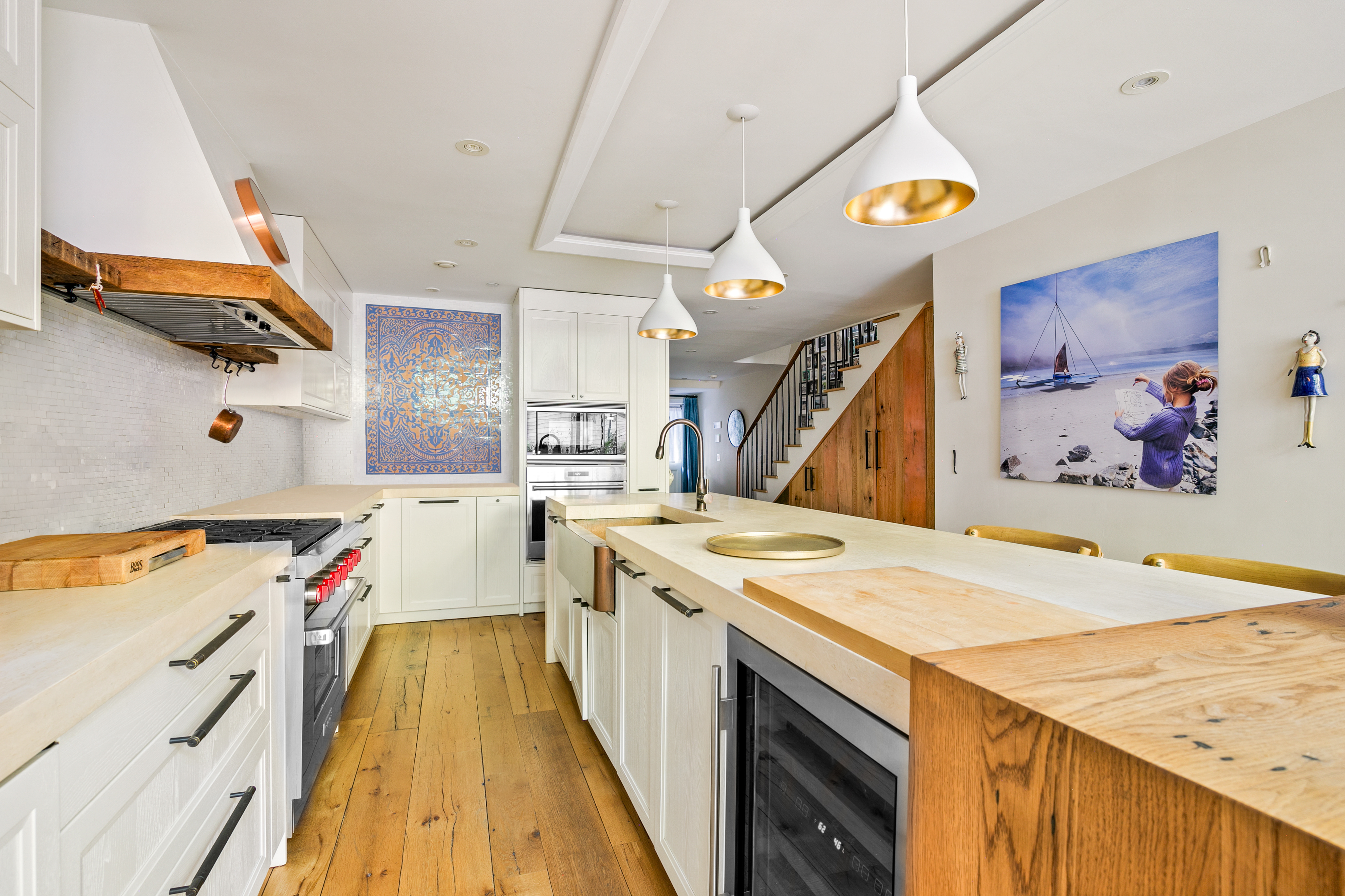 152 West 13th Street Manhattan, NY 10011 - Photo 4 of 28 a open kitchen with a stove a sink and a wooden floor