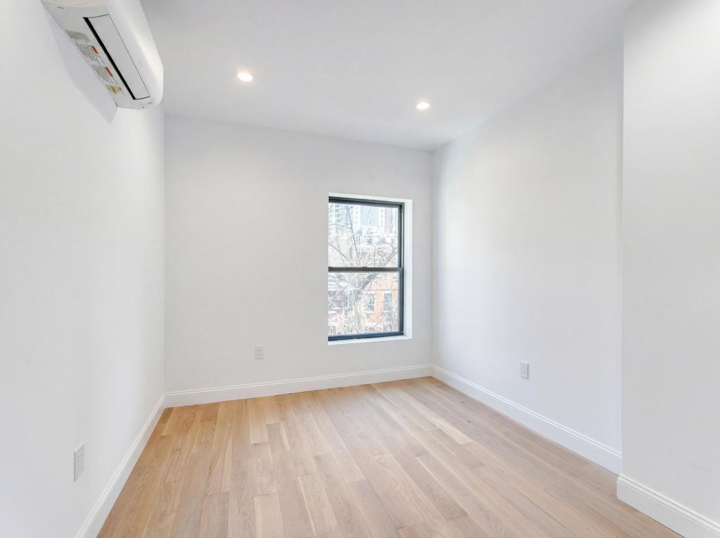 231 East 60th Street, Unit 2 New York, NY 10022 - Photo 4 of 9 an empty room with a window