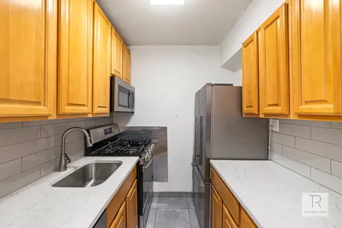 a kitchen with a sink a refrigerator and a stove