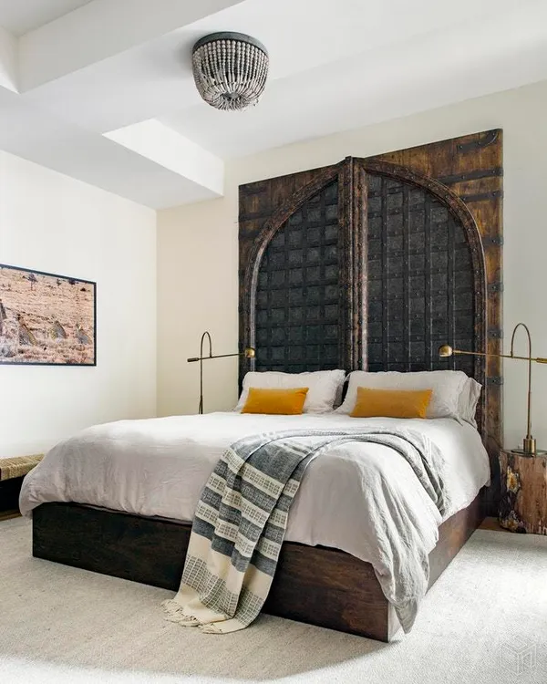 a bedroom with a bed and a painting on the wall