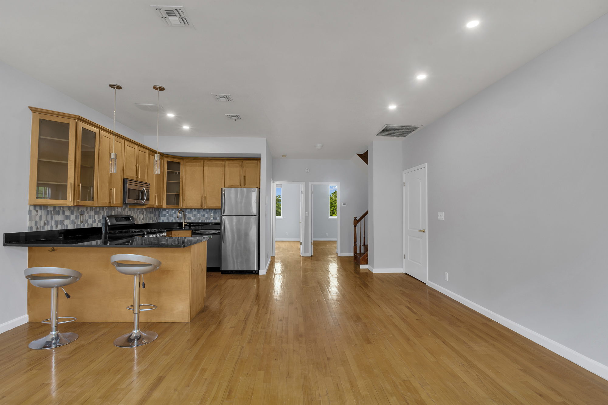 963 Kent Avenue, Unit D3 Brooklyn, NY 11205 - Photo 2 of 16 a open kitchen with stainless steel appliances granite countertop a stove and a wooden floors