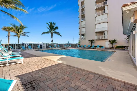 a view of swimming pool with palm trees