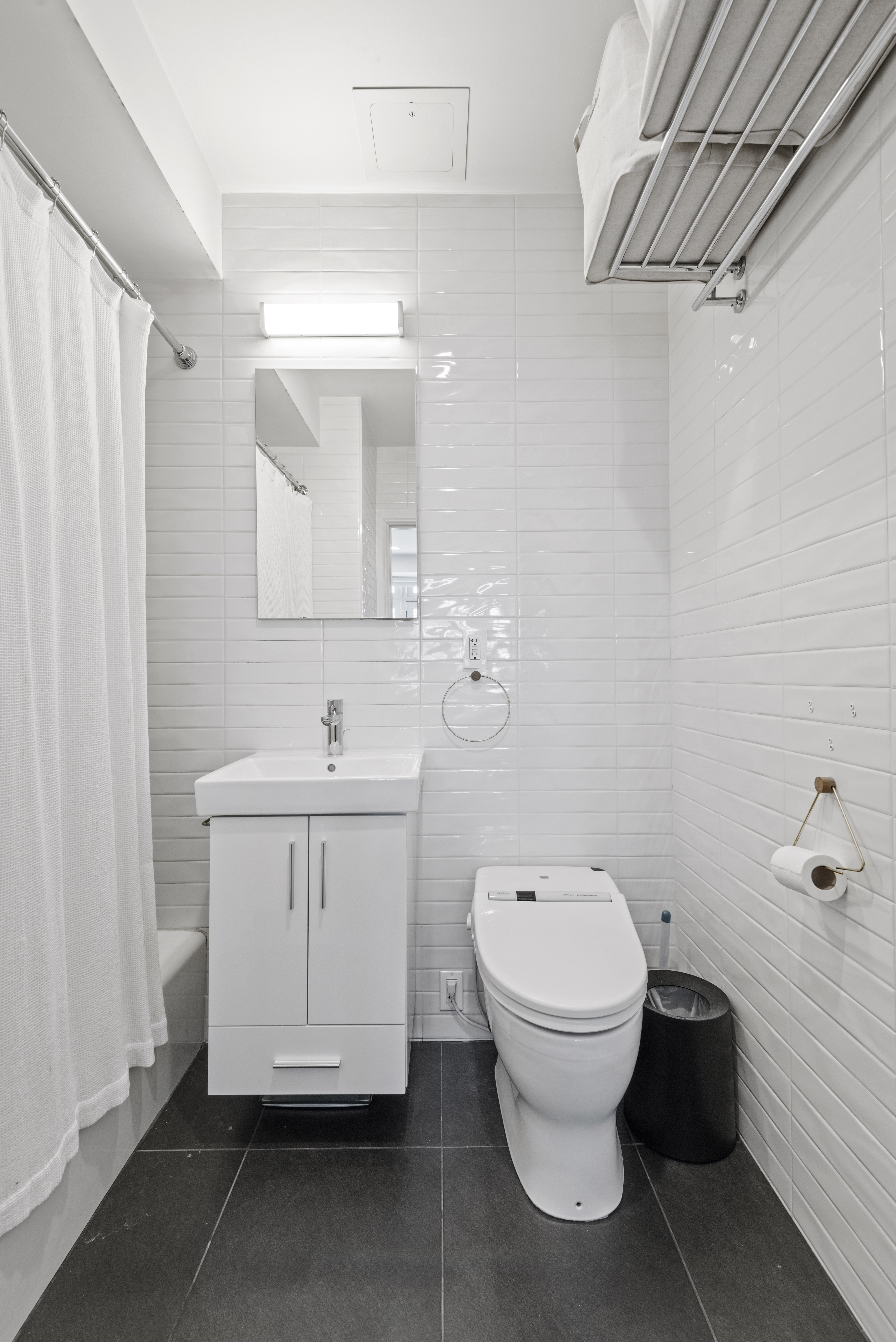 347 3rd Street, Unit C4A Brooklyn, NY 11215 - Photo 9 of 11 a bathroom with a toilet sink and mirror