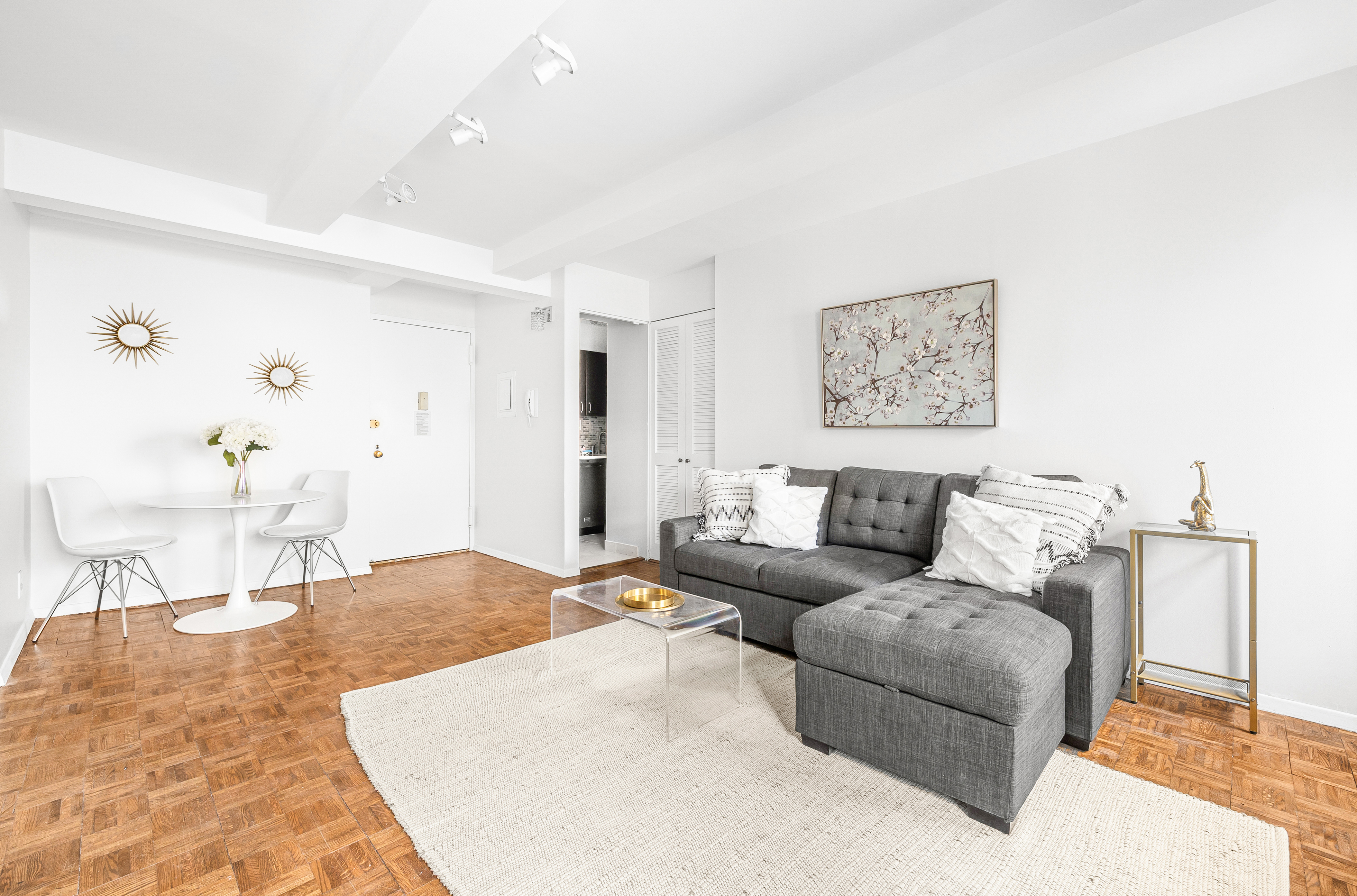 235 East 49th Street, Unit 6G Manhattan, NY 10017 - Photo 4 of 22 a living room with furniture and a painting