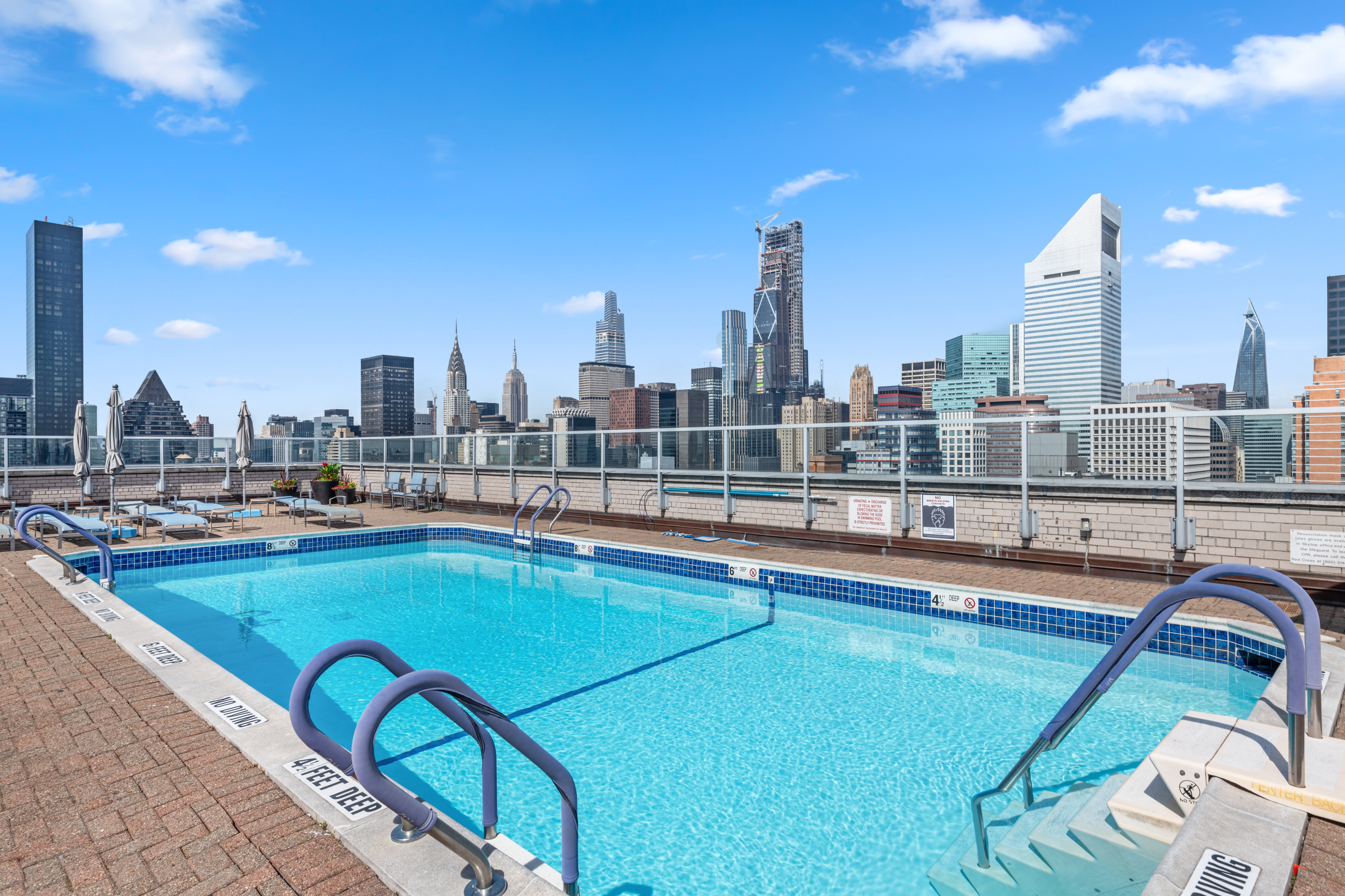 400 East 56th Street, Unit 3D Manhattan, NY 10022 - Photo 17 of 24 a view of swimming pool with outdoor seating and city view