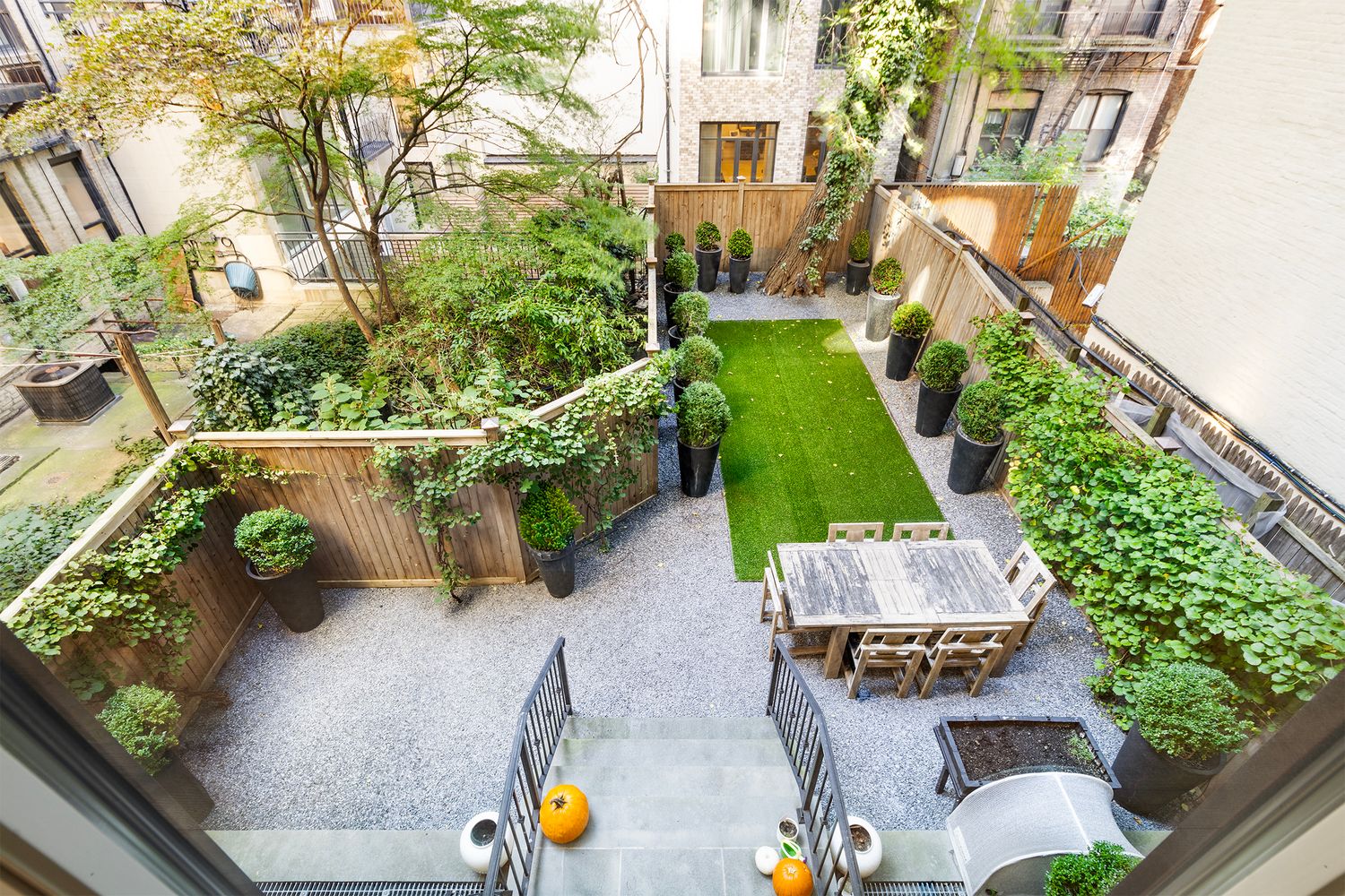 554 East 82nd Street, Unit 1/2 Manhattan, NY 10028 - Photo 11 of 13 an aerial view of a house having patio with potted plants