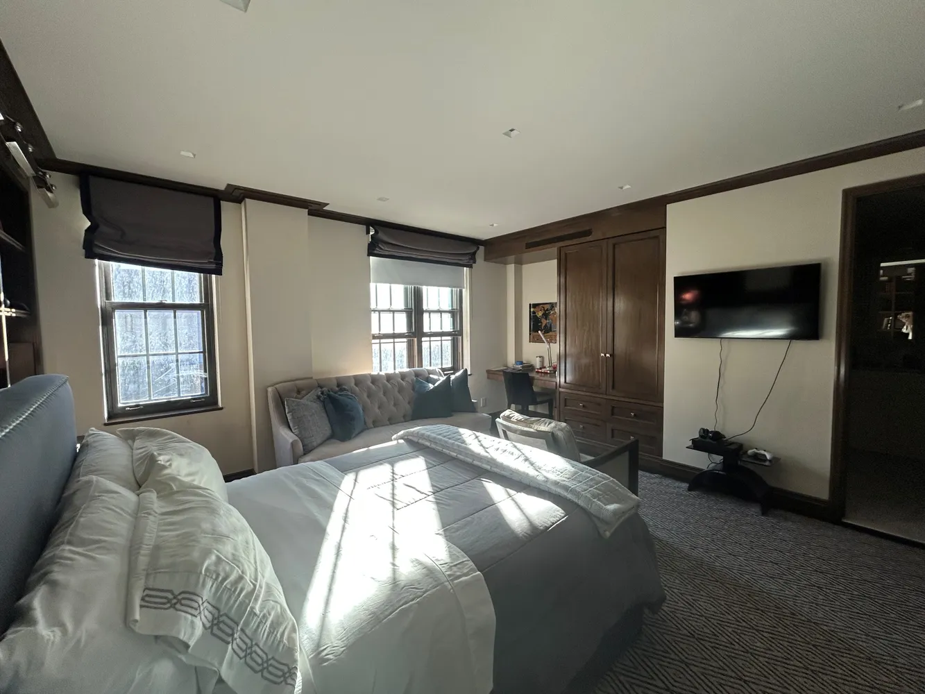 a spacious bedroom with a bed and a window