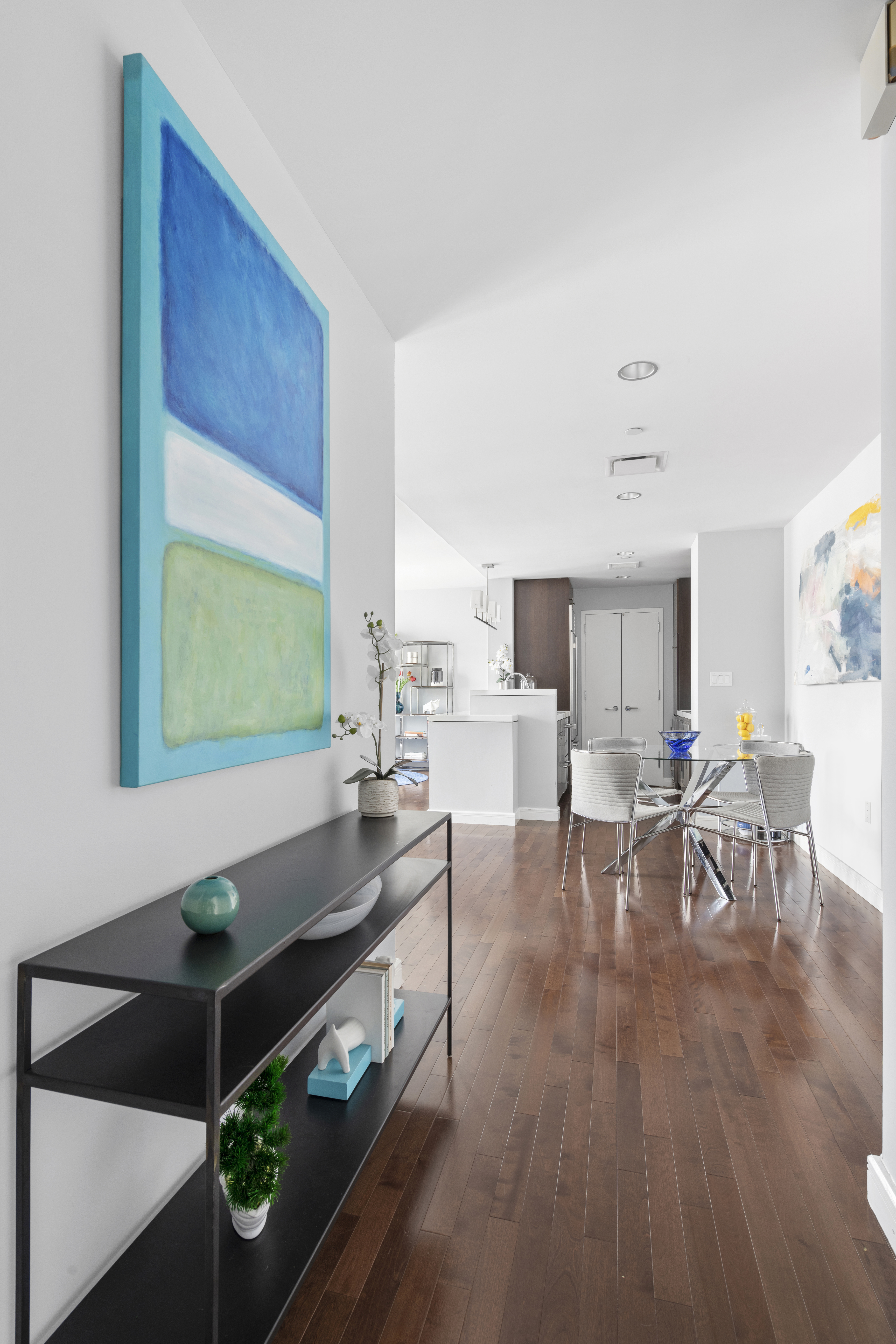 225 East 34th Street, Unit 21I Manhattan, NY 10016 - Photo 9 of 24 a living room with furniture and a wooden floor