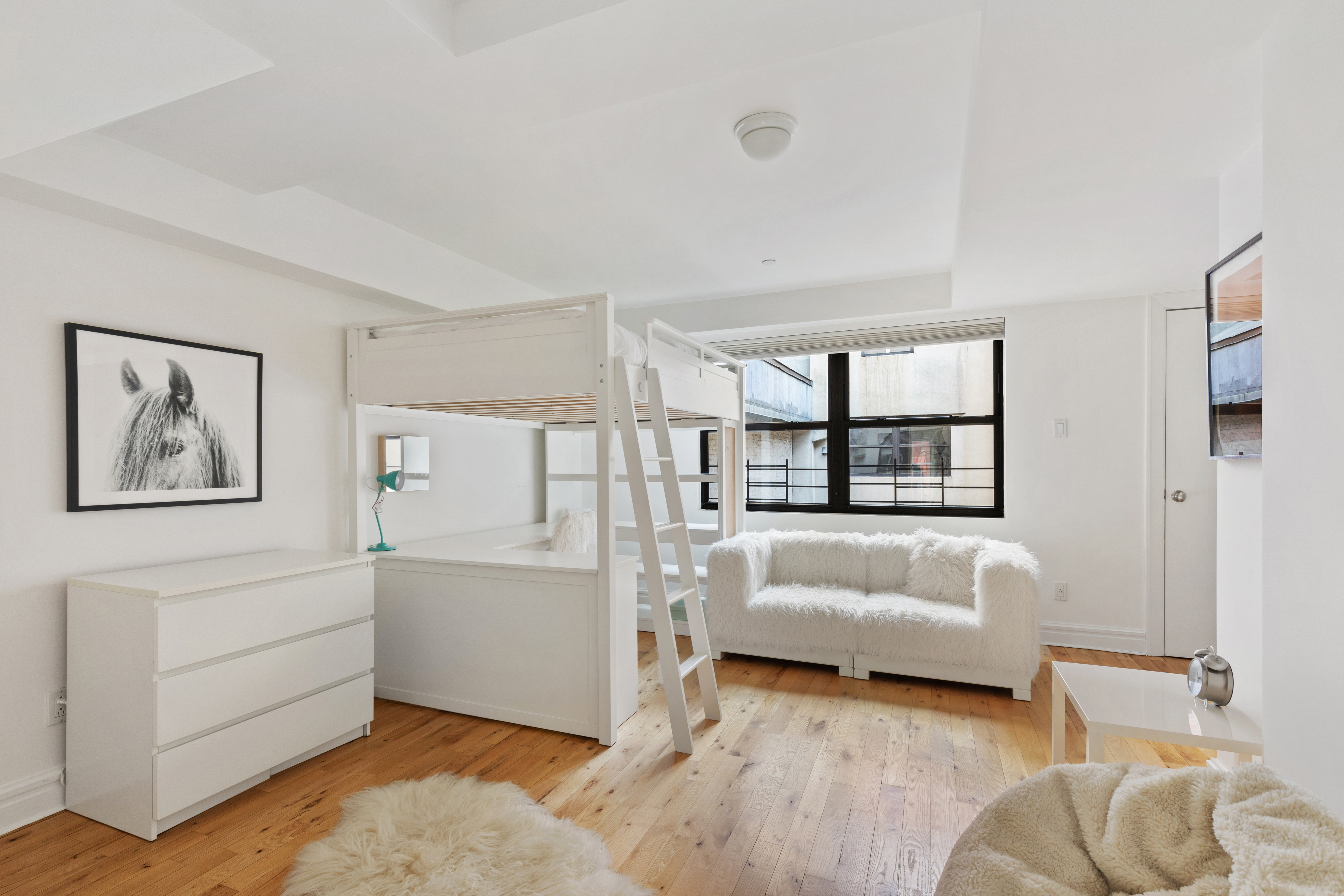 79 Laight Street, Unit 5H Manhattan, NY 10013 - Photo 10 of 13 a spacious bedroom with a bed and a couch