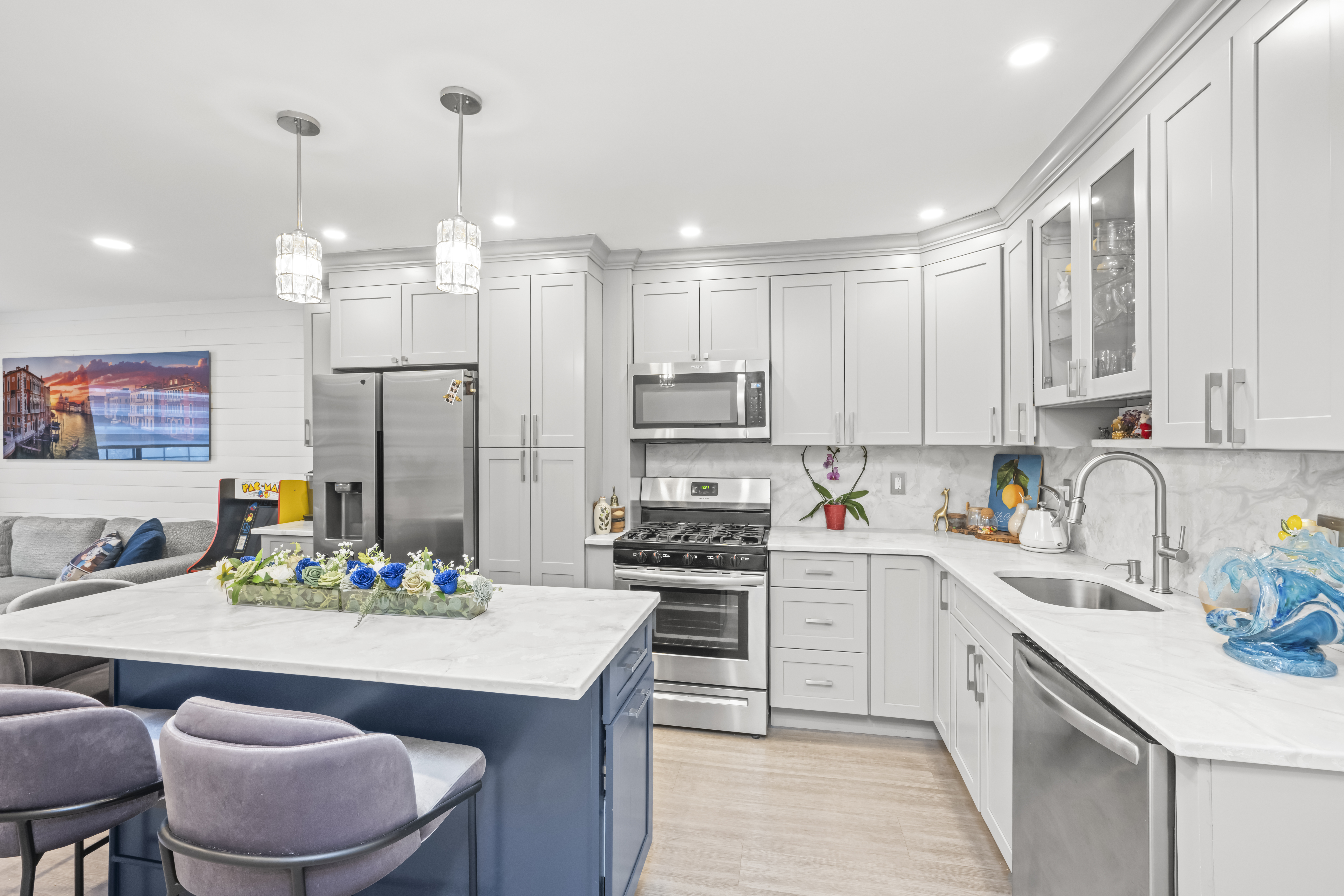a kitchen with kitchen island granite countertop a white cabinets and chairs