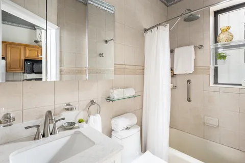 a bathroom with a sink toilet and shower