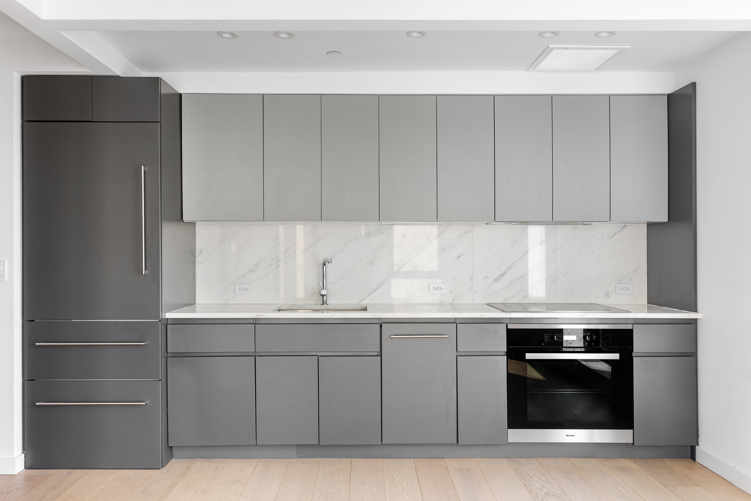 300 West 30th Street, Unit 7F Manhattan, NY 10001 - Photo 3 of 11 a kitchen with a sink and a stove top oven