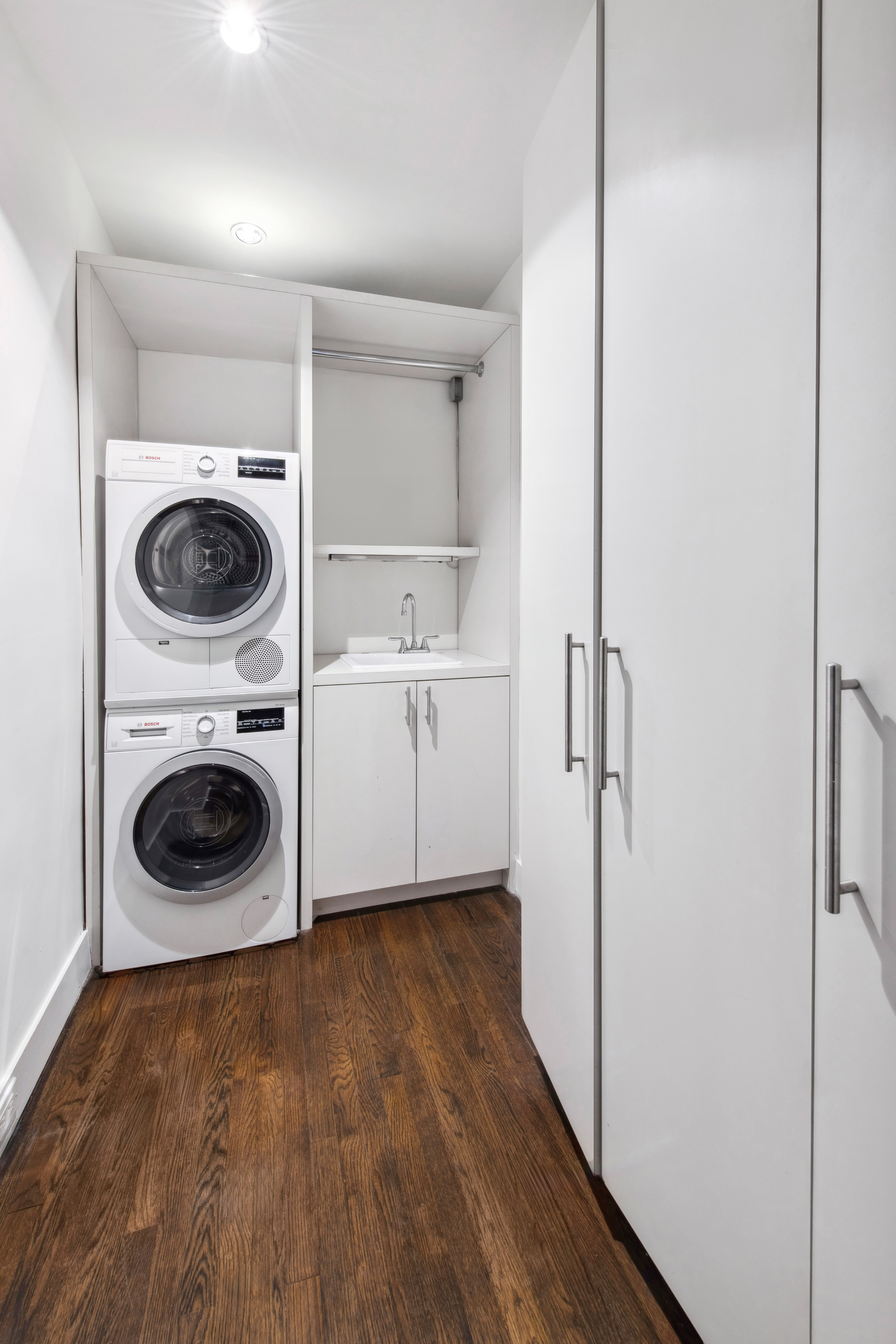 330 East 70th Street, Unit 5AB Manhattan, NY 10021 - Photo 12 of 13 a view of a hallway with washer and dryer