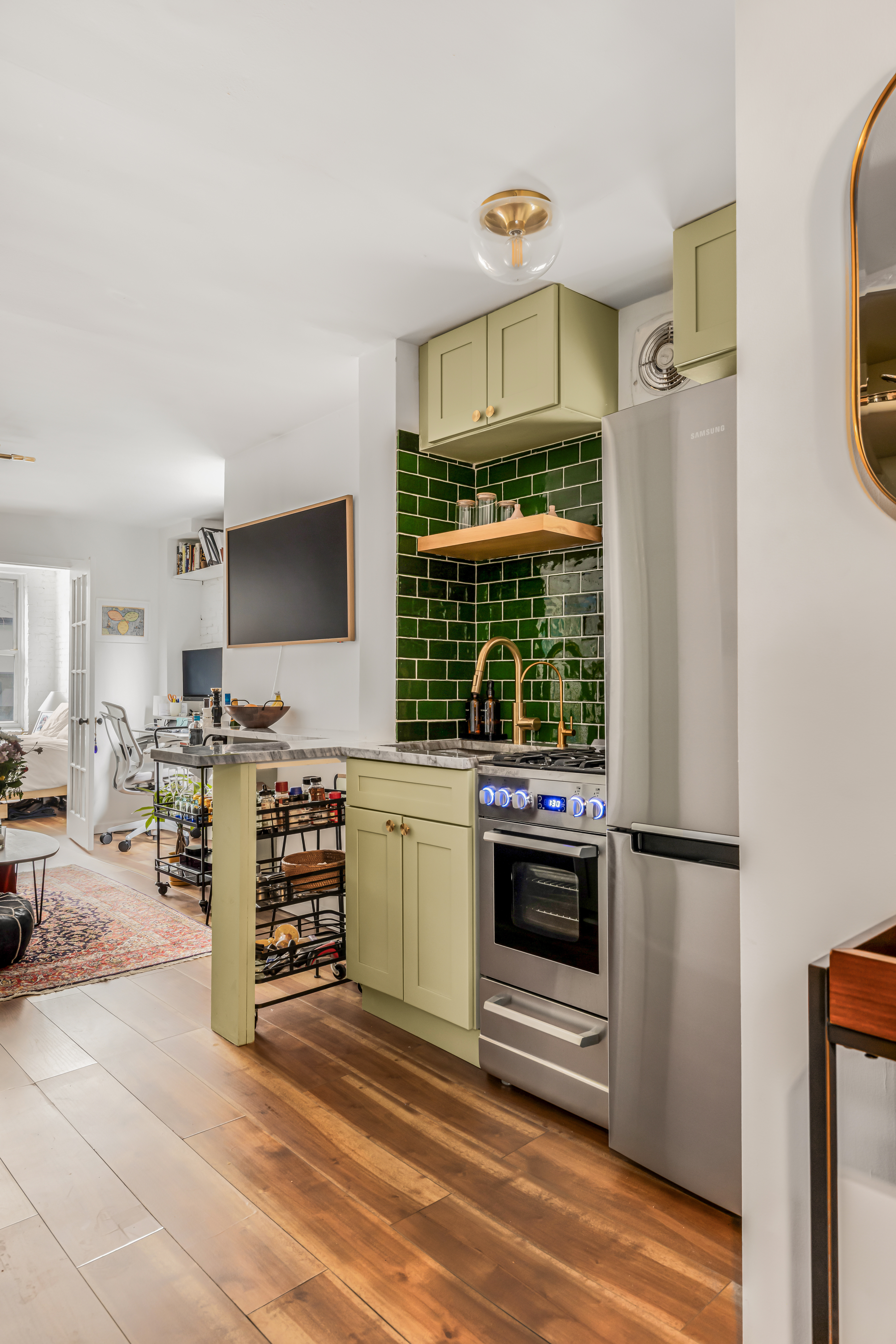 15 Jones Street, Unit 5D Manhattan, NY 10014 - Photo 2 of 7 a kitchen with stainless steel appliances a stove and a refrigerator