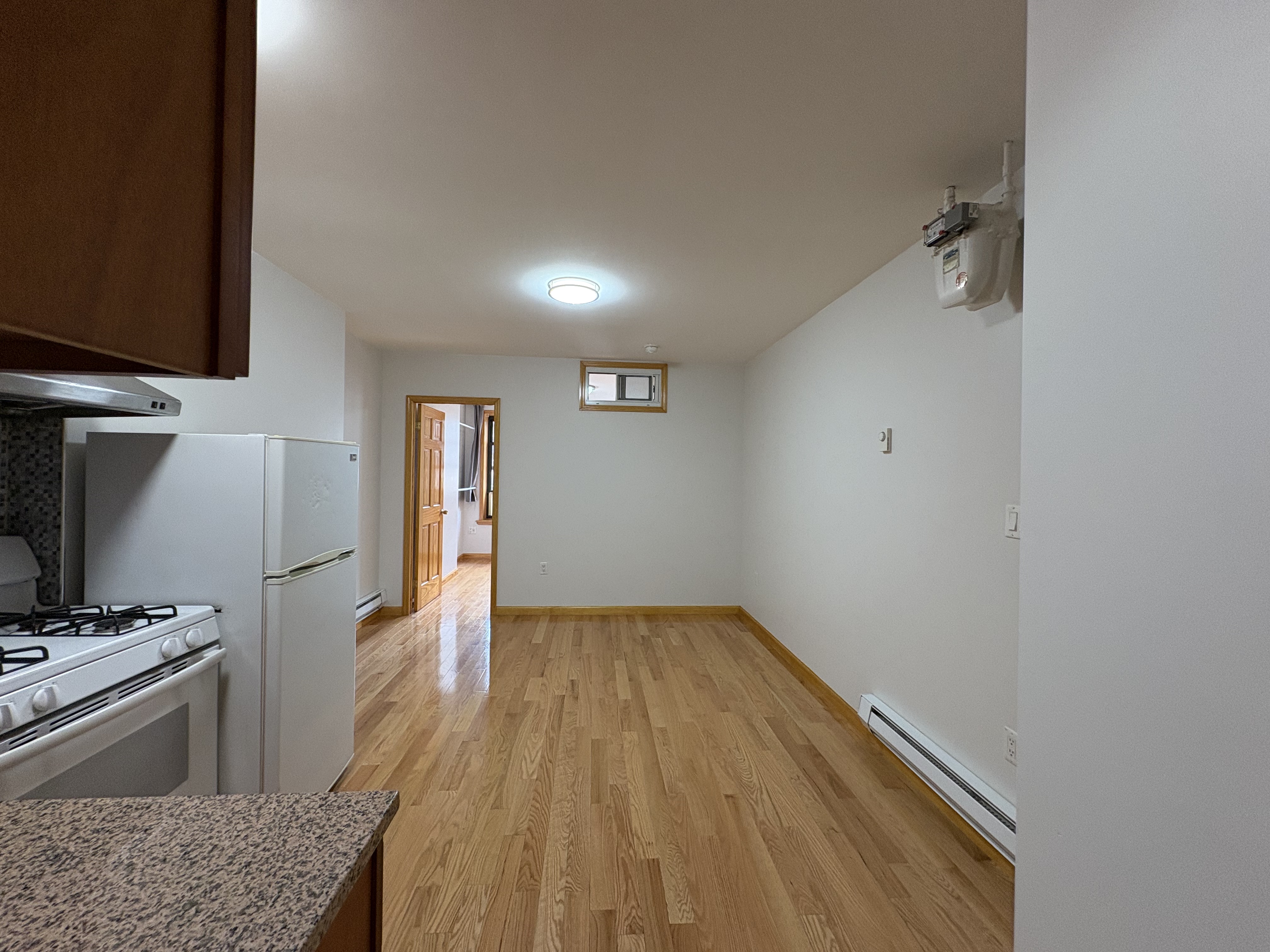 38 Ludlow Street, Unit 15 Manhattan, NY 10002 - Photo 7 of 16 a view of a kitchen cabinets a sink and dishwasher