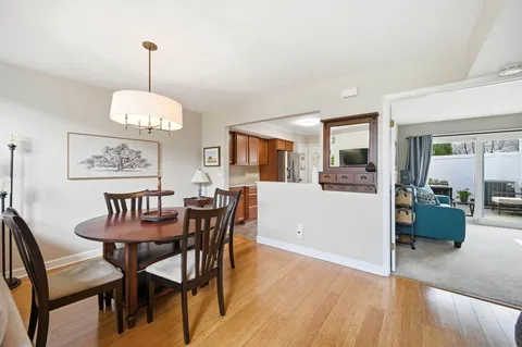 a view of a dining room with furniture wooden floor and chandelier
