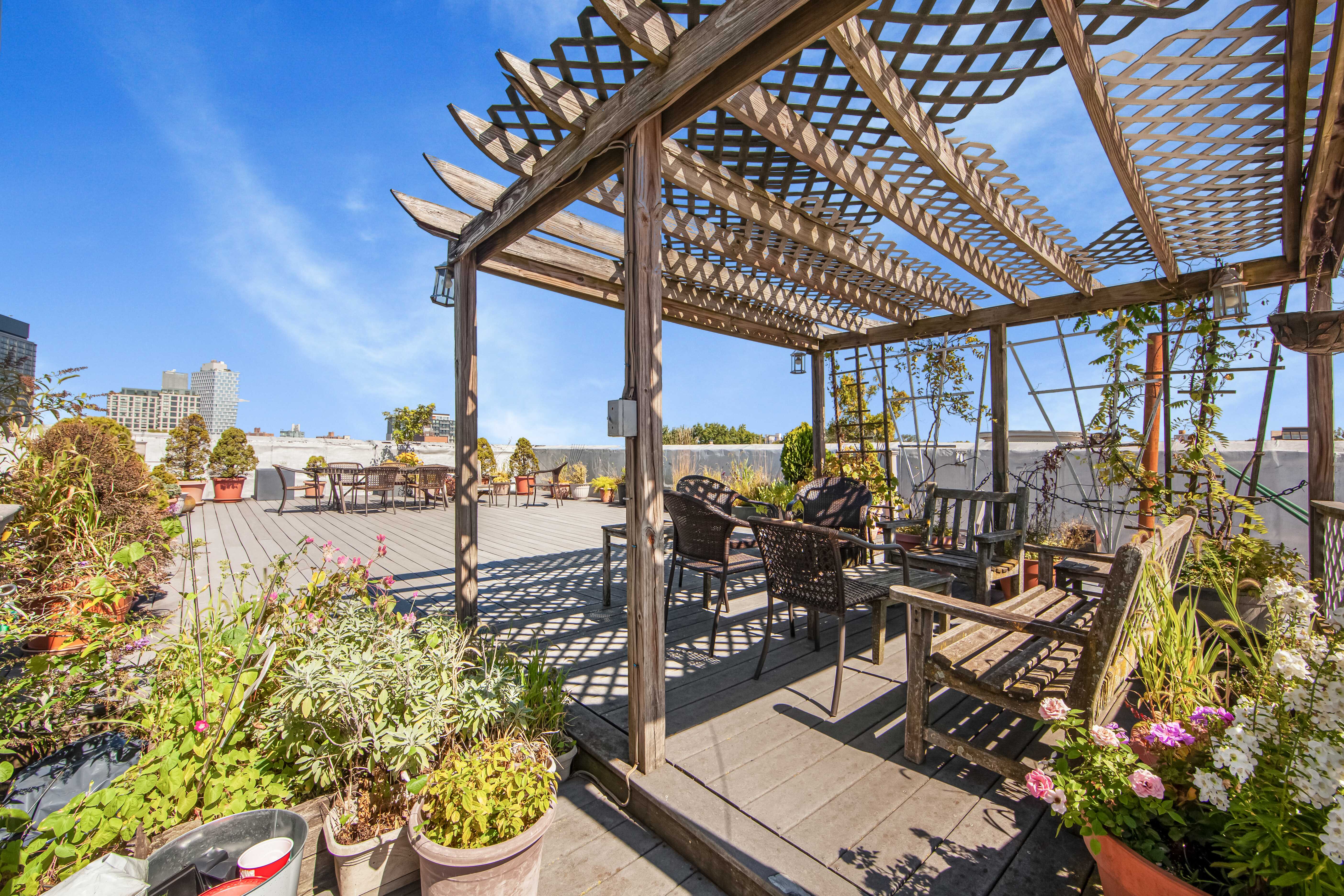 254 Park Place, Unit 4B Brooklyn, NY 11238 - Photo 9 of 12 a view of a patio with dining table and chairs and potted plants