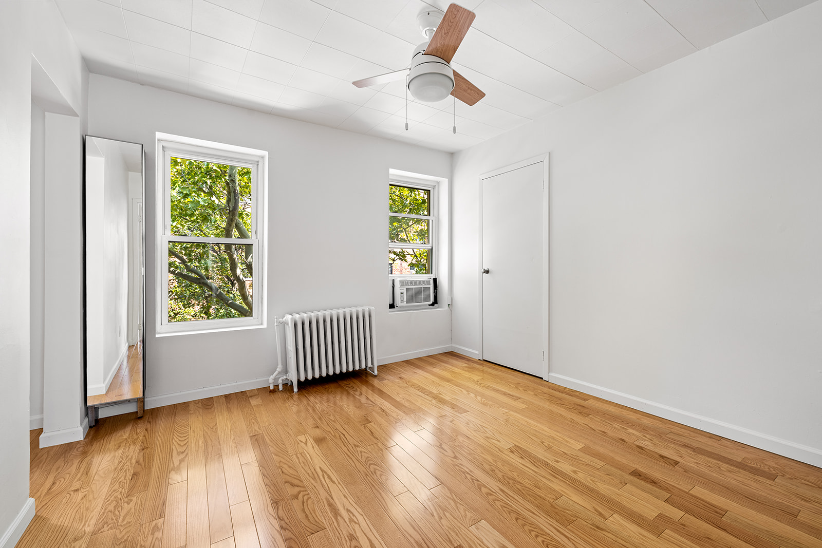 44 1st Street, Unit 2 Brooklyn, NY 11231 - Photo 2 of 6 an empty room with wooden floor and windows