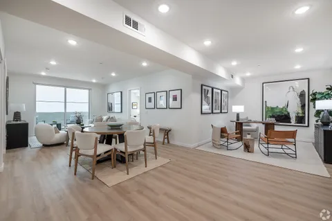a view of a dining room with furniture window and wooden floor