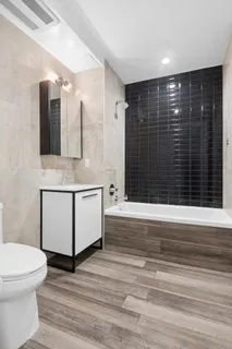 a bathroom with a sink a toilet and mirror