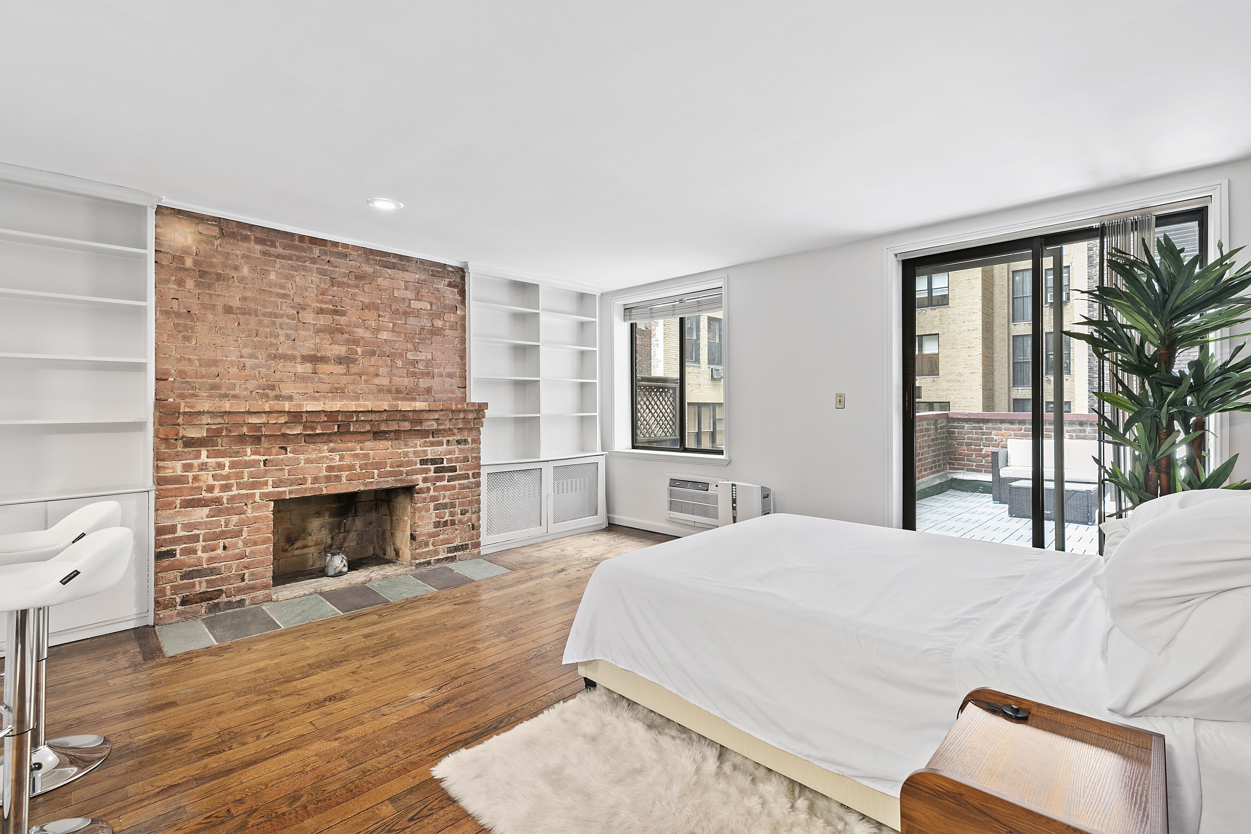 a bedroom with a bed and a fireplace