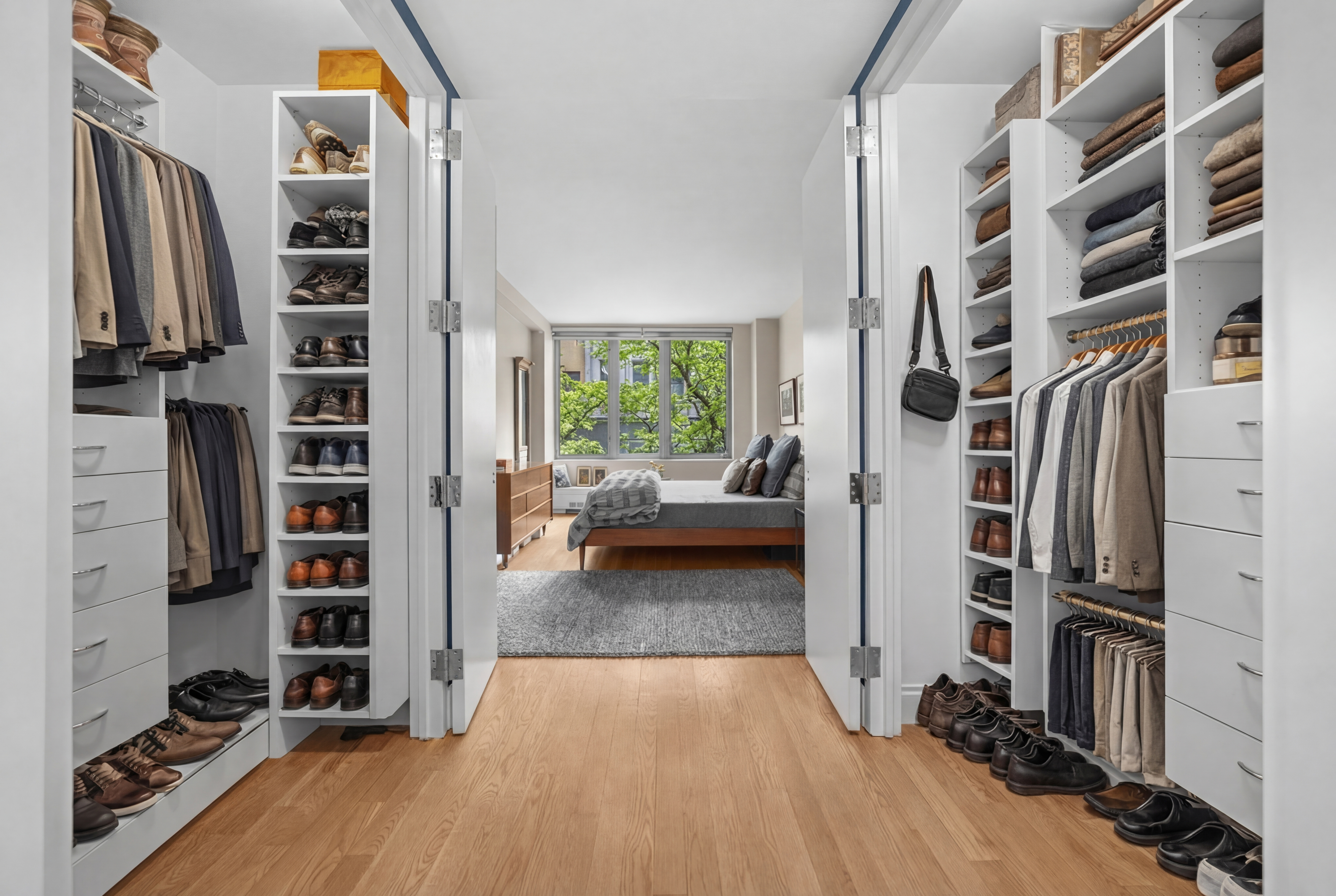 117 West 123rd Street, Unit 1B Manhattan, NY 10027 - Photo 10 of 25 a view of walk in closet with clothes and shoes