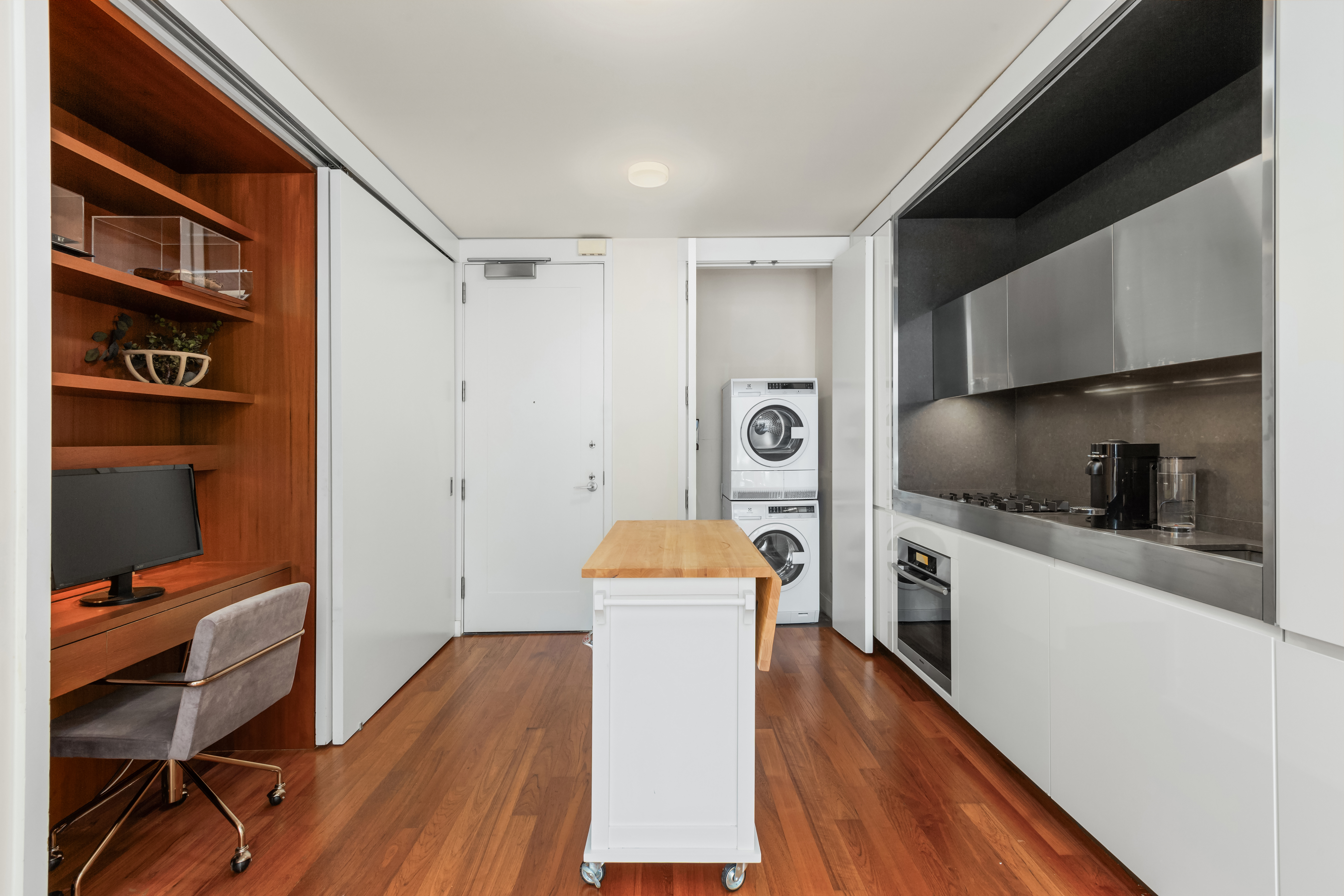15 William Street, Unit 7B Manhattan, NY 10005 - Photo 3 of 9 a kitchen with a refrigerator and a stove top oven