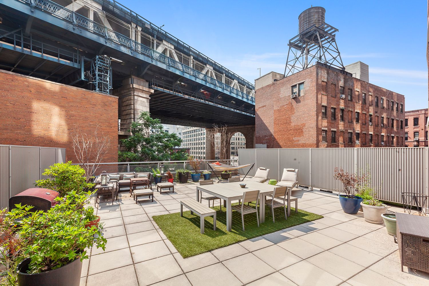100 Jay Street, Unit 4H Brooklyn, NY 11201 - Photo 3 of 13 a view of a patio with couches table and chairs potted plants
