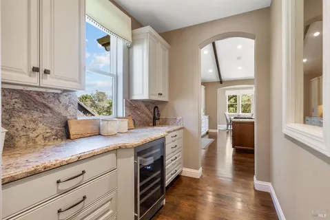 a kitchen with granite countertop a sink a stove and cabinets