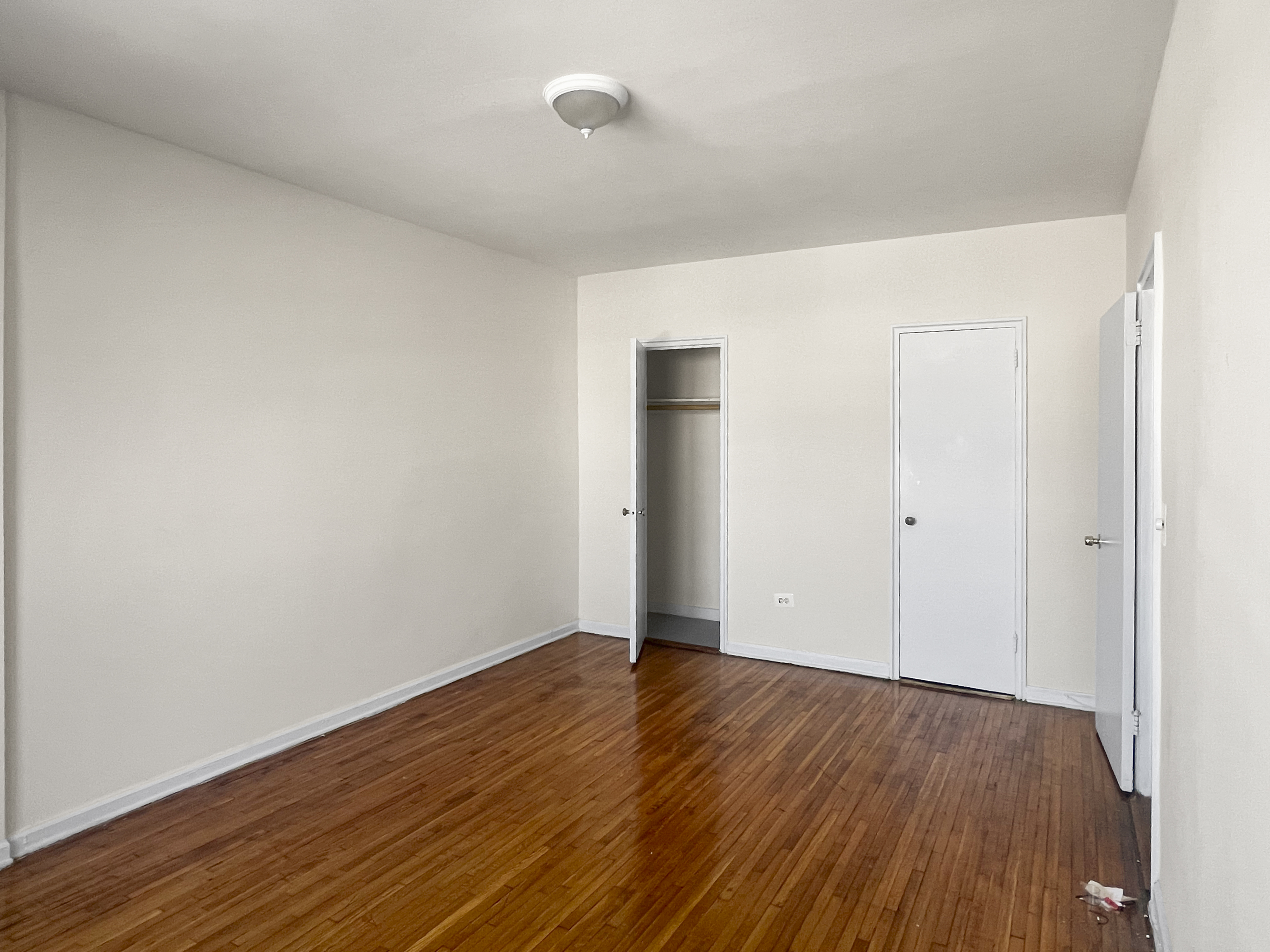 1466 East Gun Hill Road, Unit 1B Bronx, NY 10469 - Photo 4 of 5 a view of an empty room with wooden floor