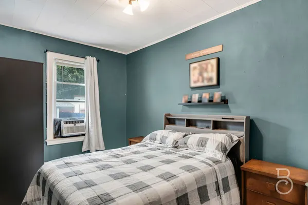 a bedroom with a bed and a lamp on table