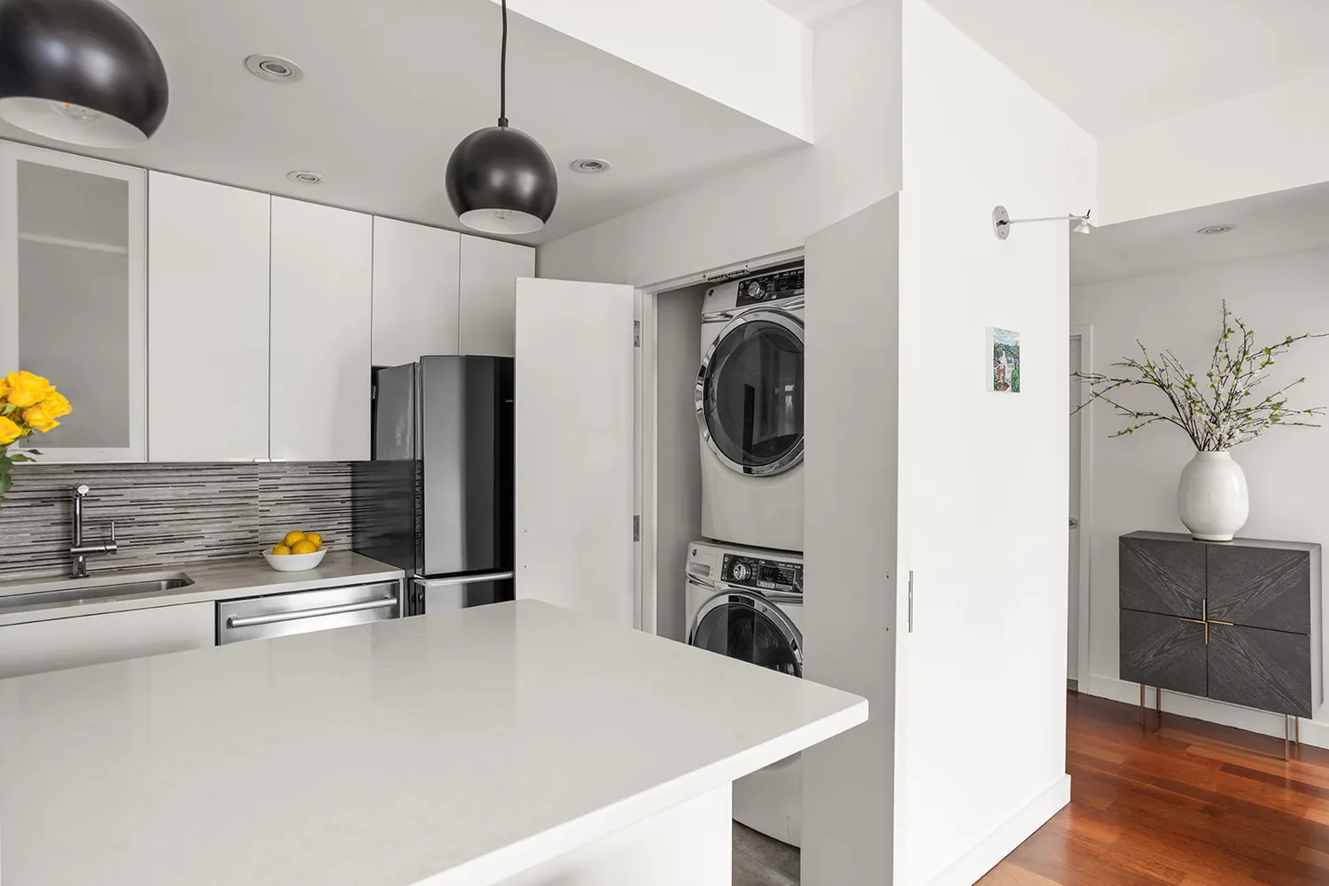 a kitchen with stainless steel appliances a stove a refrigerator a sink a counter space and cabinets