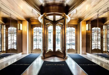 a large room with a large bed and large windows