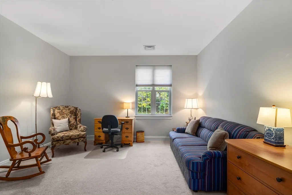 a living room with furniture and a lamp