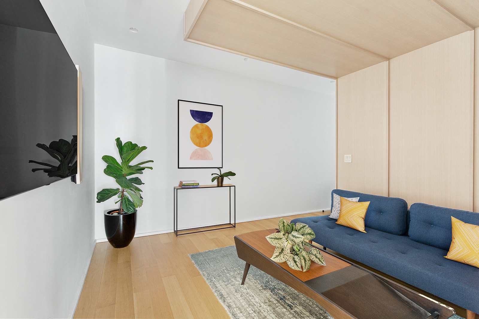 318 West 52nd Street, Unit 3N Manhattan, NY 10019 - Photo 6 of 9 a living room with furniture and a potted plant