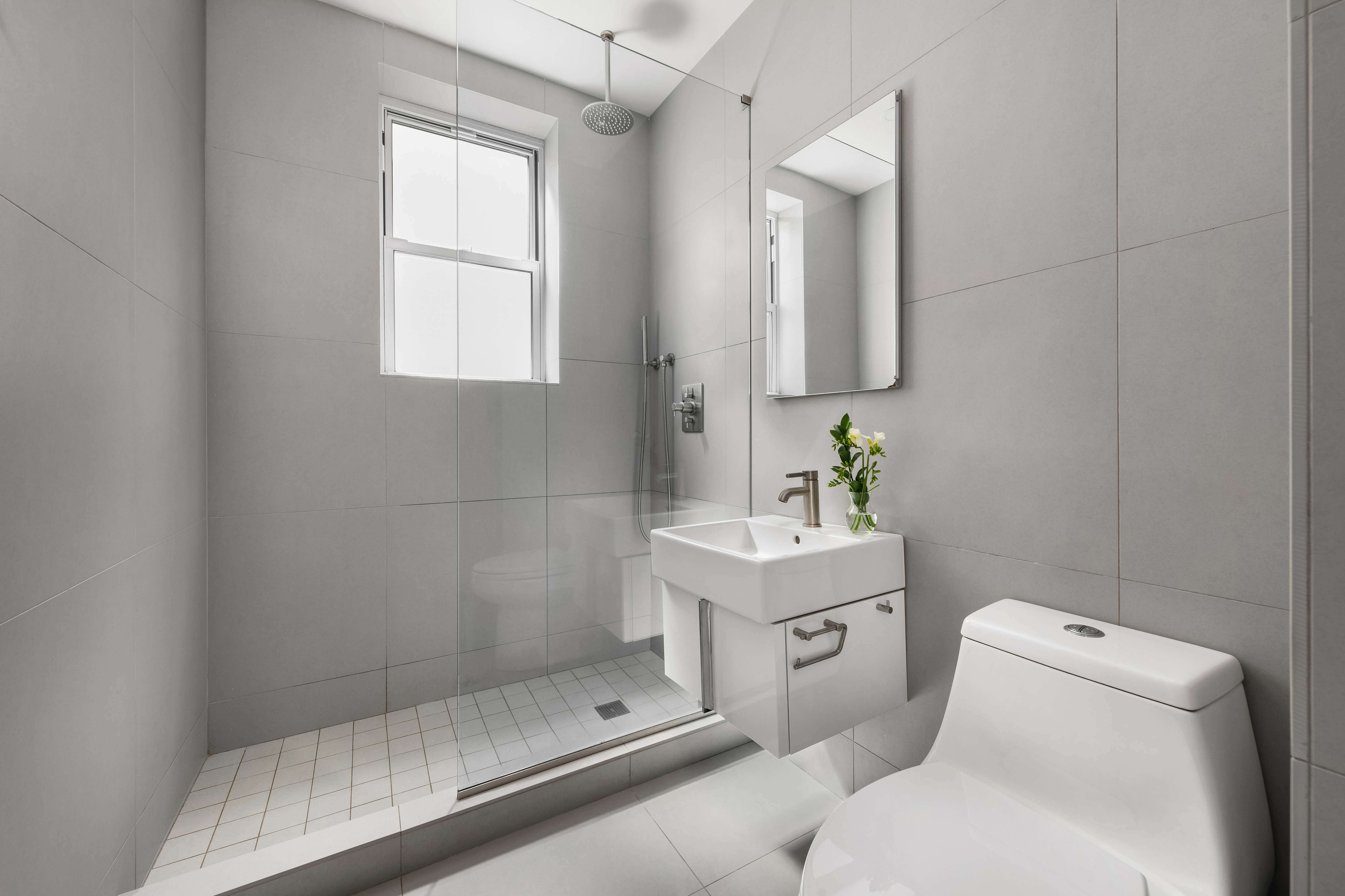 150 East 93rd Street, Unit 6AC Manhattan, NY 10128 - Photo 11 of 17 a bathroom with a sink toilet and shower