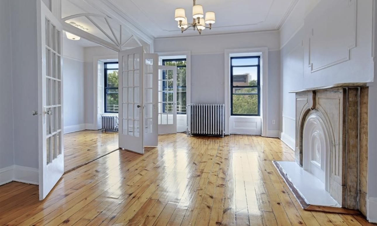 a view of an entryway with wooden floor and a livingroom